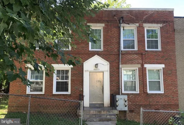 front view of a brick house with a large window