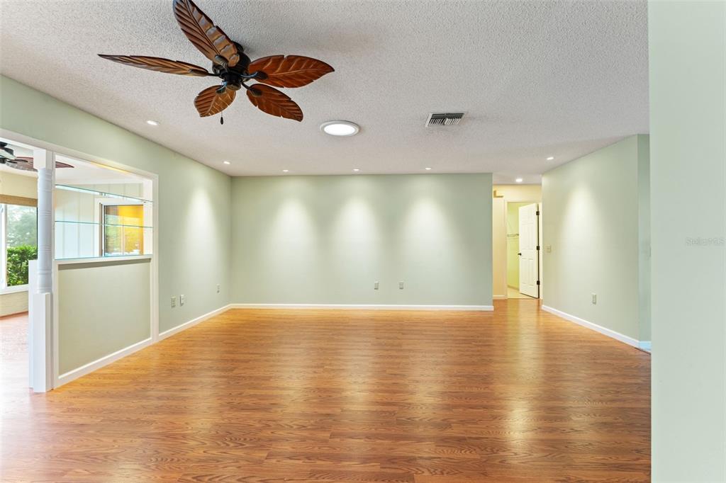 2233 Timber Lodge Lane Spring Hill, FL 34606 - Photo 11 of 59 a view of an empty room with wooden floor and a window