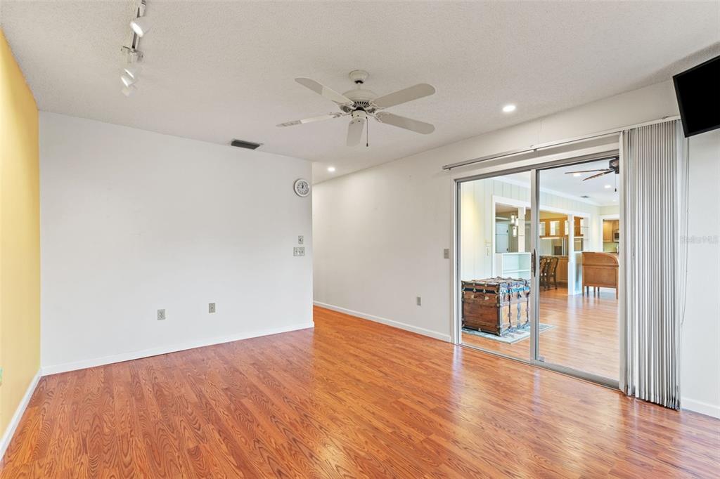 2233 Timber Lodge Lane Spring Hill, FL 34606 - Photo 23 of 59 an empty room with wooden floor and ceiling fan