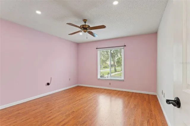 a bathroom with a granite countertop sink a toilet and bathtub