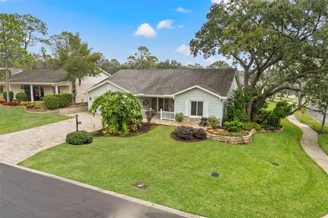 a view of house with backyard and garden