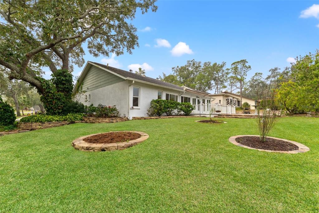 2233 Timber Lodge Lane Spring Hill, FL 34606 - Photo 42 of 59 a front view of a house with garden