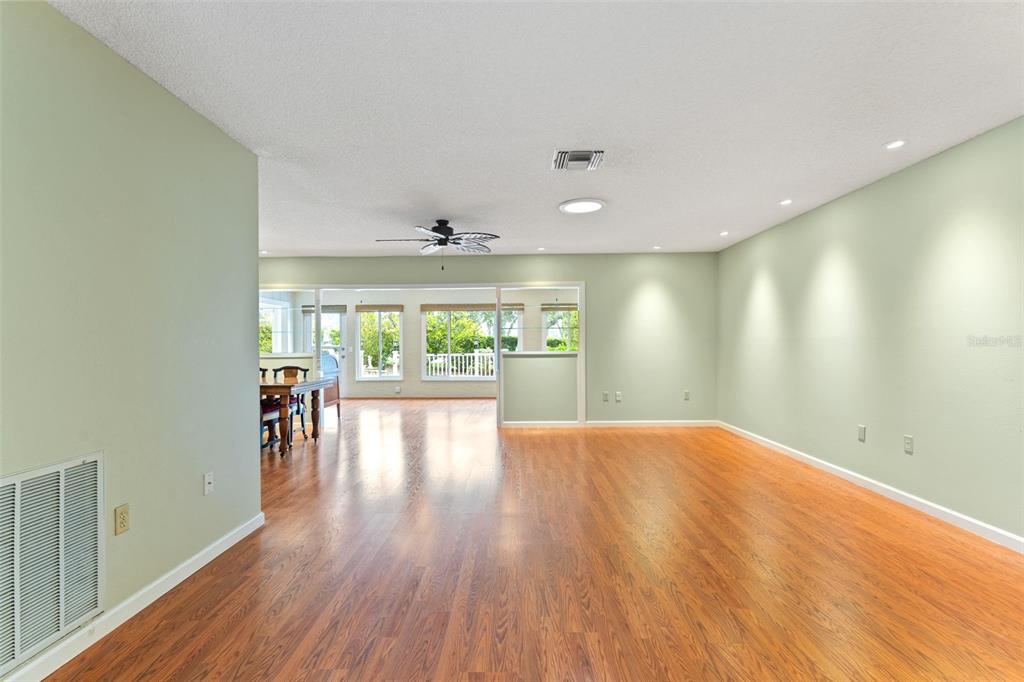 2233 Timber Lodge Lane Spring Hill, FL 34606 - Photo 9 of 59 a view of an empty room with wooden floor