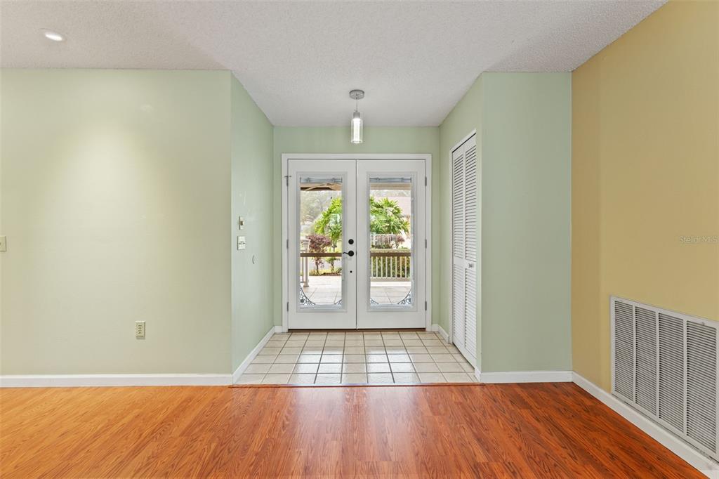 2233 Timber Lodge Lane Spring Hill, FL 34606 - Photo 10 of 59 an empty room with wooden floor and windows