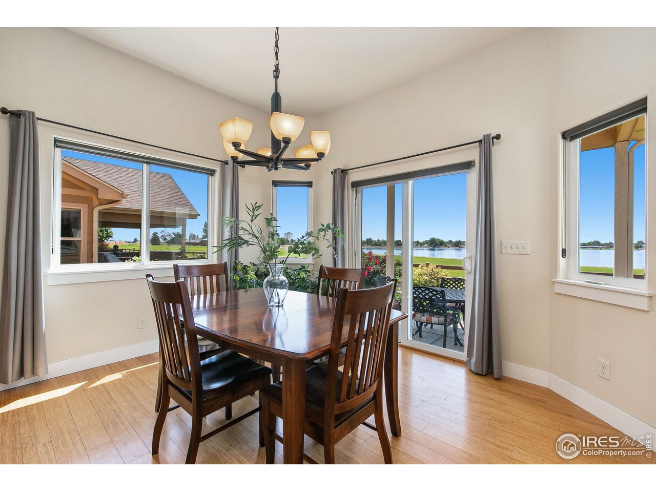 55 Veronica Drive Windsor, CO 80550 - Photo 11 of 24 Formal dining space off the open kitchen and living room with views of the lake.