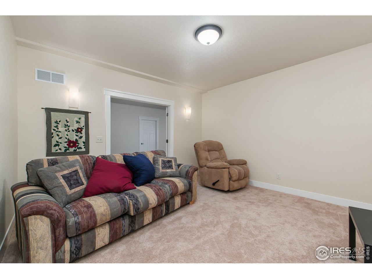 55 Veronica Drive Windsor, CO 80550 - Photo 18 of 24 Potential movie room tucked away in the basement with dimmable lighting