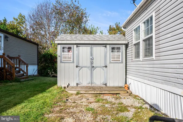 a yellow house with trees in front of it
