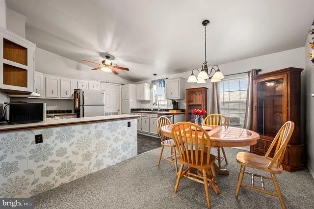 a dining room with furniture and chandelier
