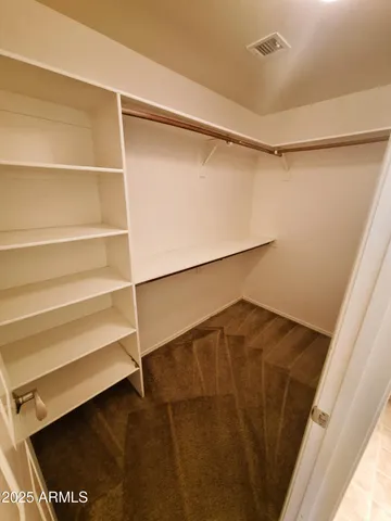 an empty room with a ceiling fan and a window