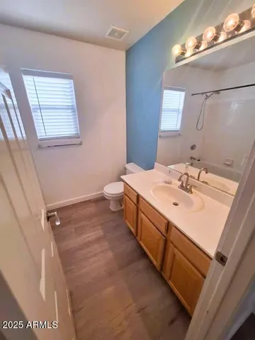 a view of a hallway with wooden floor and stairs