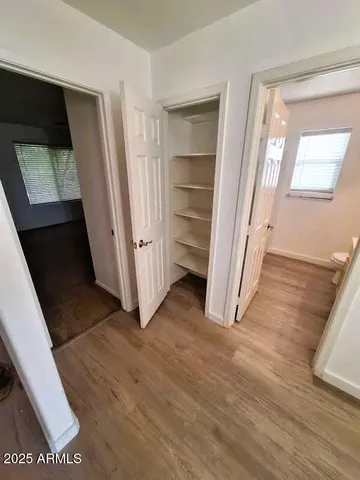 a view of a hallway with wooden floor
