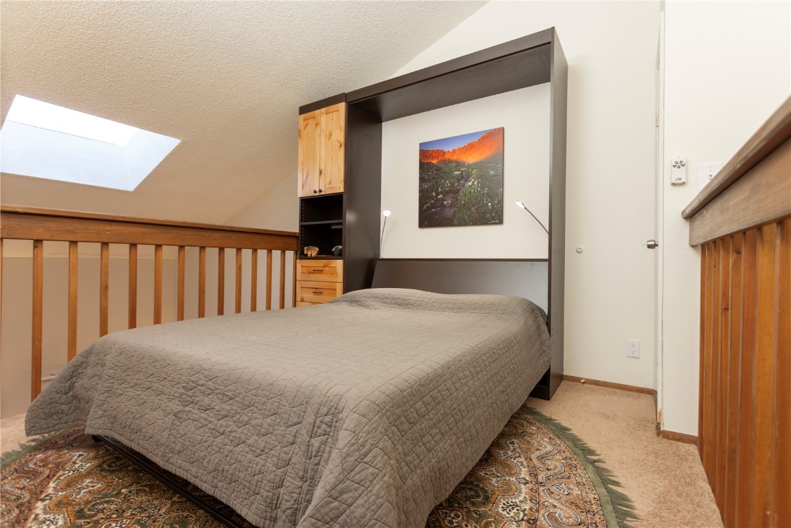 570 Bills Ranch Road, Unit 335 Frisco, CO 80443 - Photo 11 of 43 a bedroom with a bed and painting on the wall