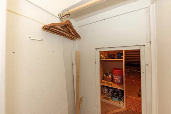 a view of a patio with furniture and a garden