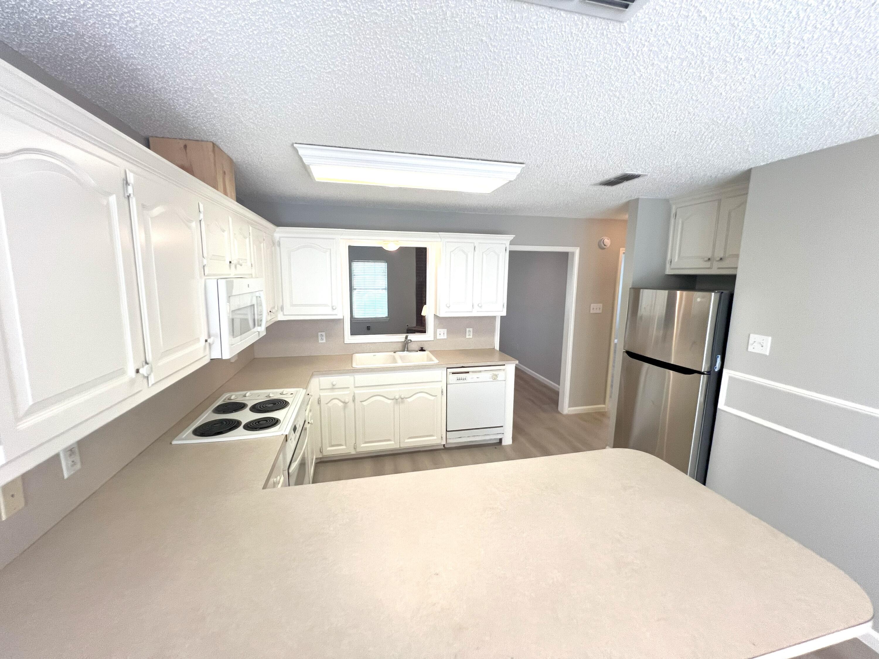 2314 Farm To Market 41 Lubbock, TX 79423 - Photo 12 of 18 a bedroom with a bed and wooden floor