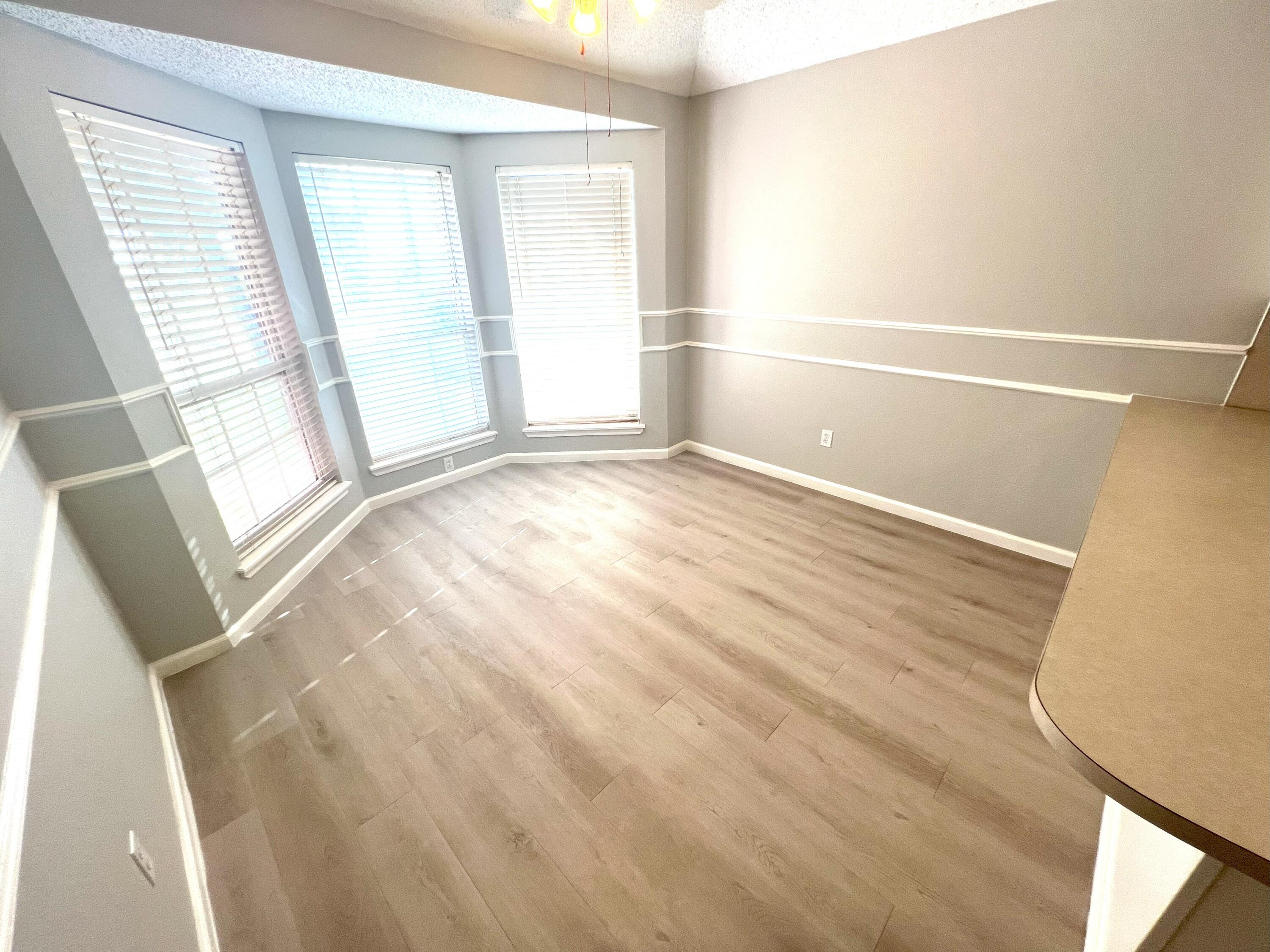 2314 Farm To Market 41 Lubbock, TX 79423 - Photo 13 of 18 a view of empty room with wooden floor and fan