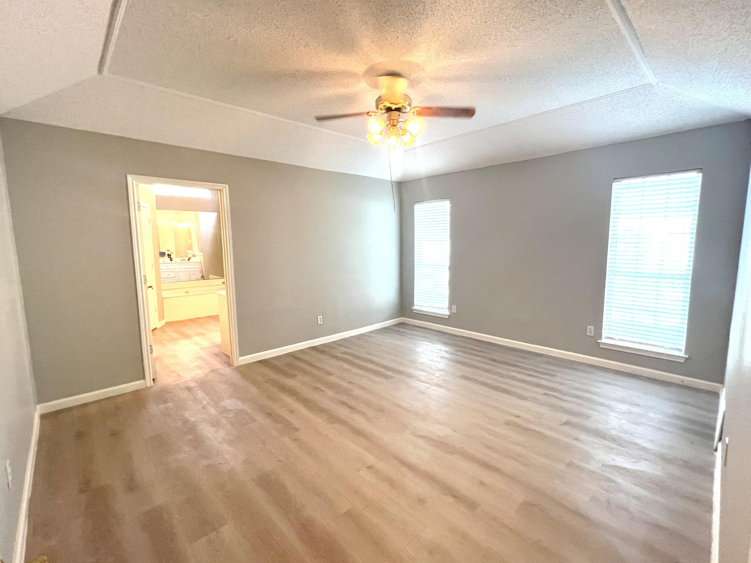 2314 Farm To Market 41 Lubbock, TX 79423 - Photo 15 of 18 a view of an empty room with wooden floor and a window