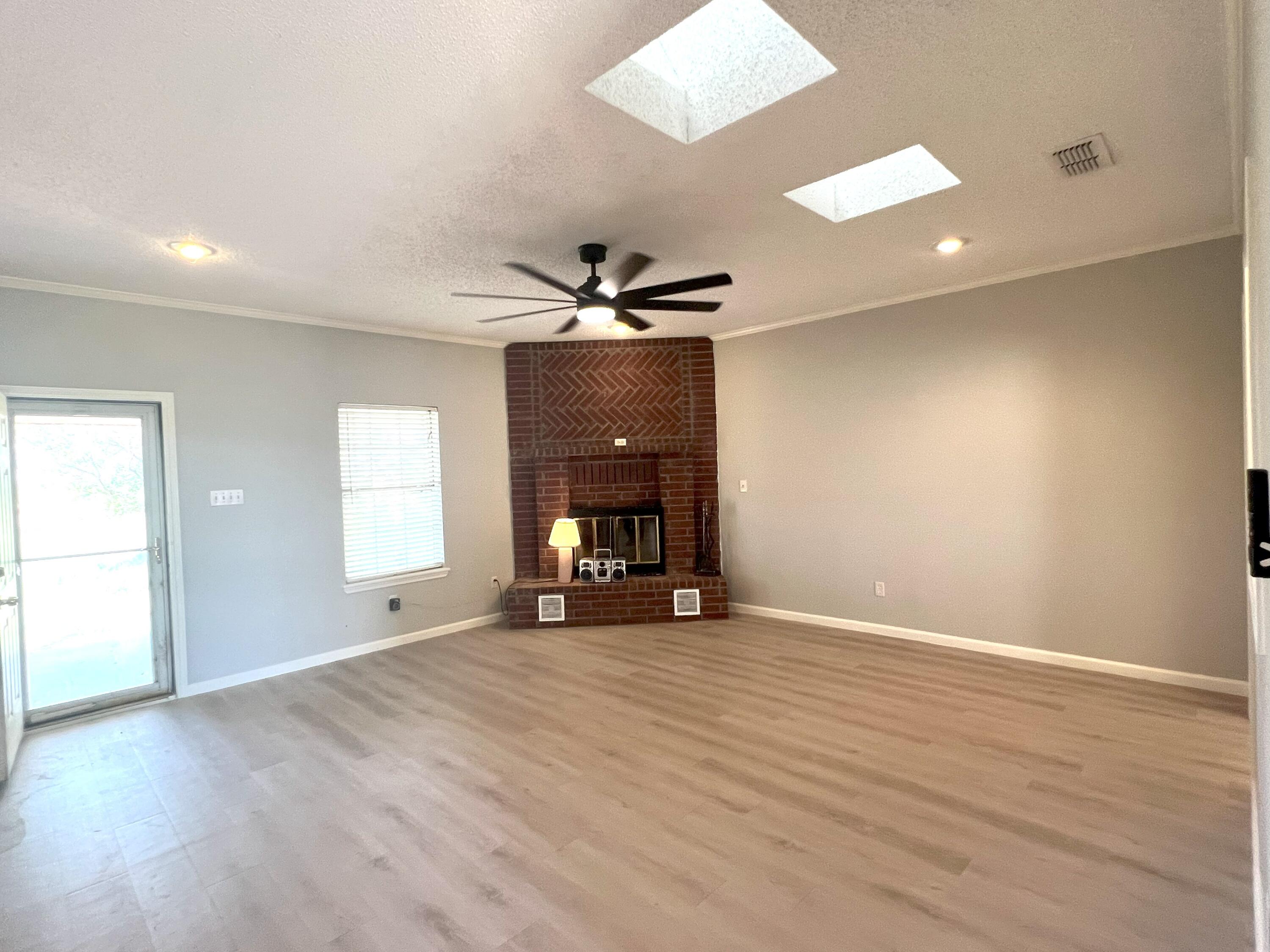 2314 Farm To Market 41 Lubbock, TX 79423 - Photo 2 of 18 an empty room with wooden floor and windows