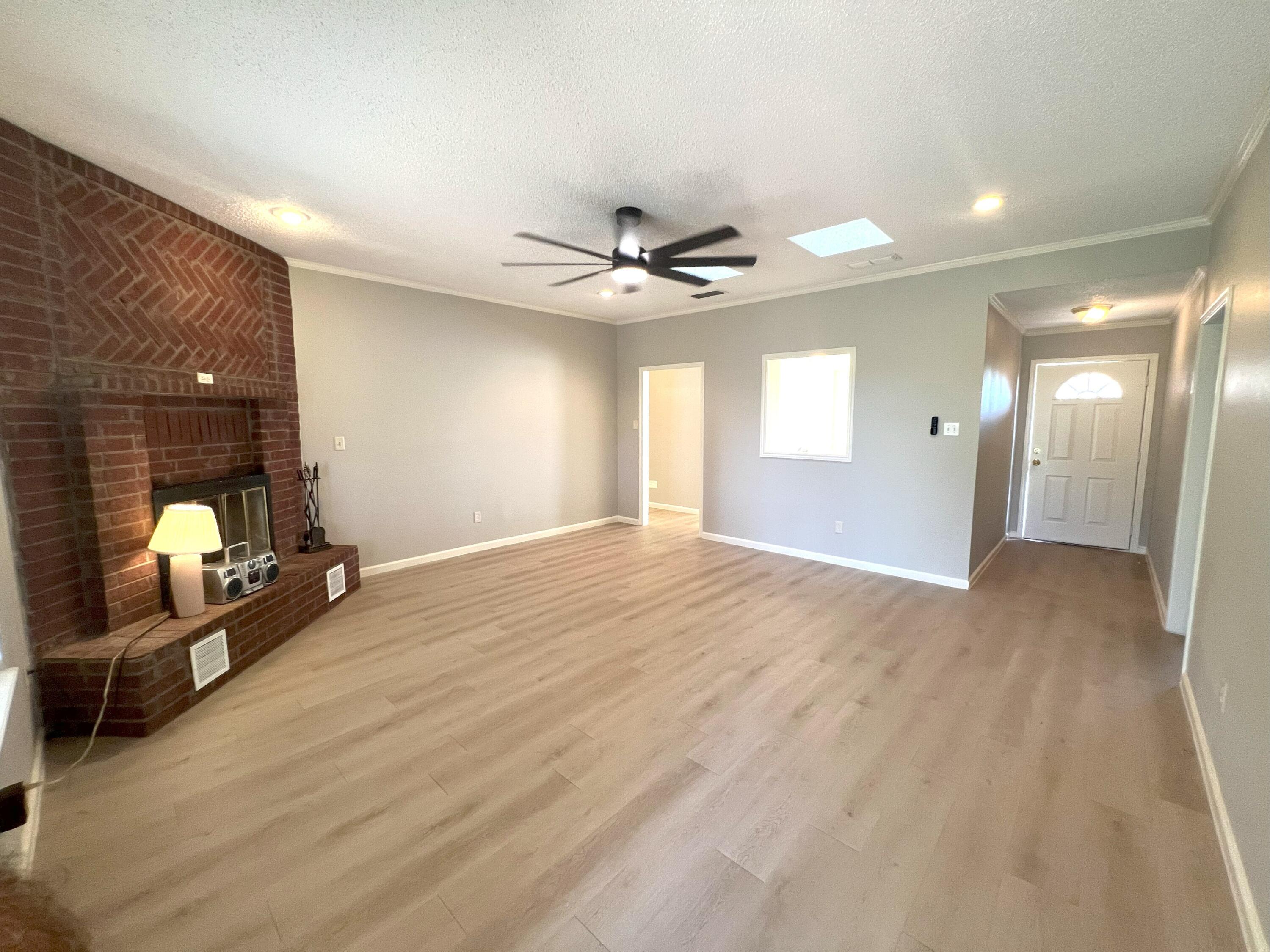 2314 Farm To Market 41 Lubbock, TX 79423 - Photo 9 of 18 a view of a livingroom with a ceiling fan and wooden floor