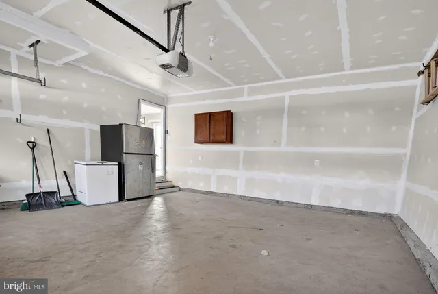 a view of a room with a refrigerator and microwave