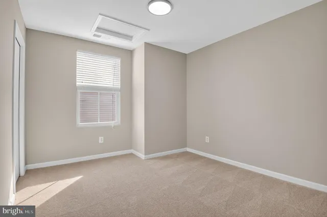 an empty room with windows and closet
