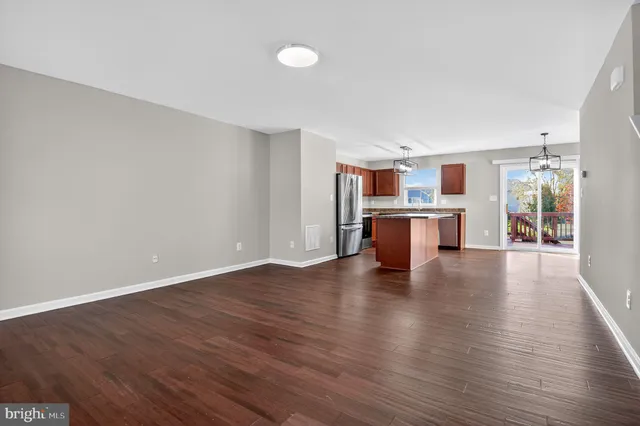 a view of a kitchen with a sink and a refrigerator
