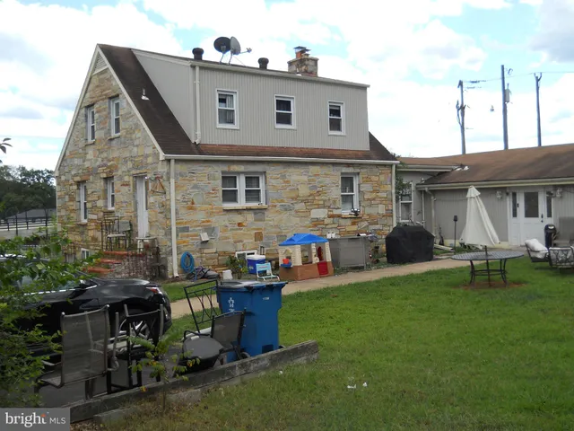 a front view of house with yard and outdoor seating
