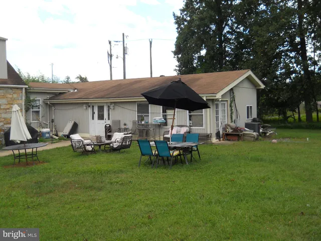 a view of a house with backyard porch and sitting area