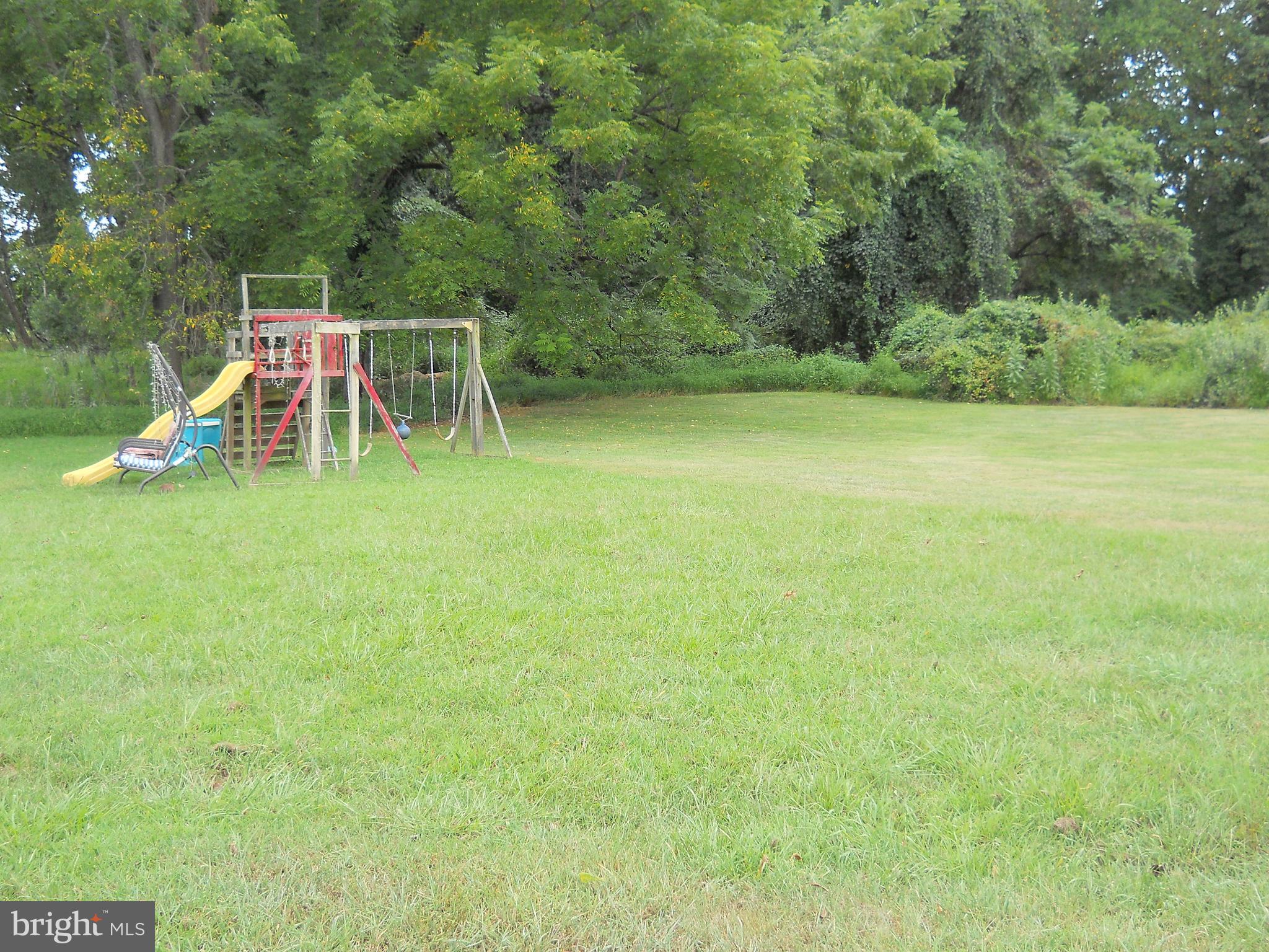 3424 Jermantown Road Fairfax, VA 22030 - Photo 16 of 19 a view of a yard with a slide and a bench