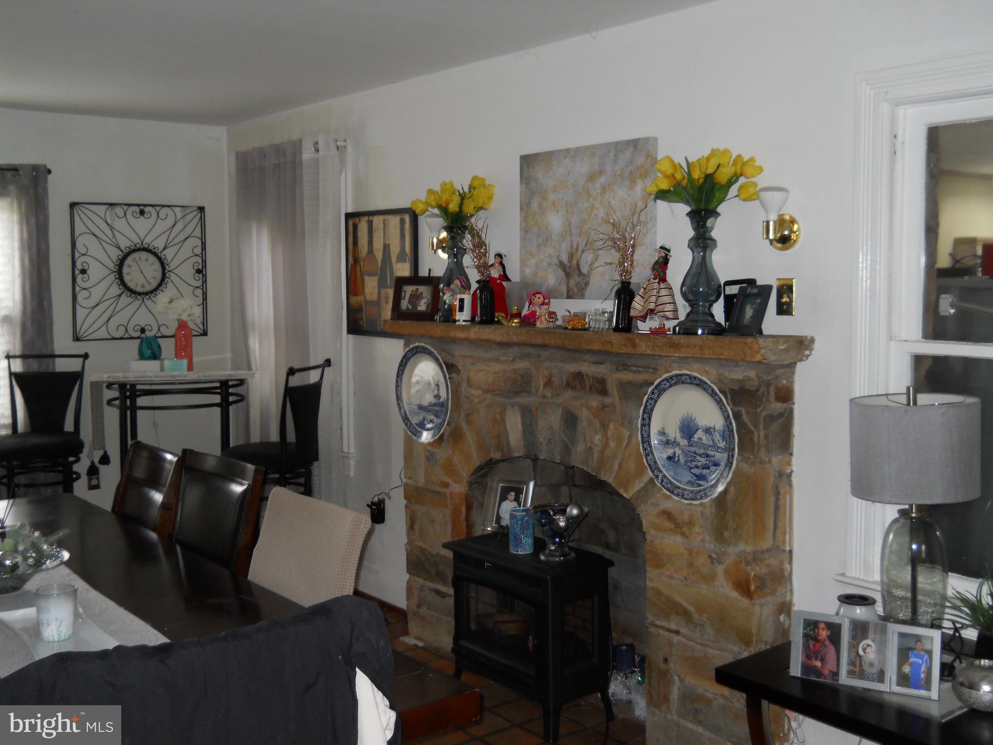 3424 Jermantown Road Fairfax, VA 22030 - Photo 4 of 19 a living room with furniture a flat screen tv and a fireplace