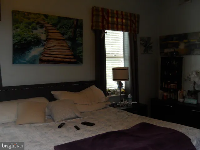 a bedroom with a bed and window