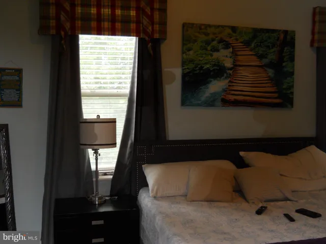 a bedroom with a bed and a window