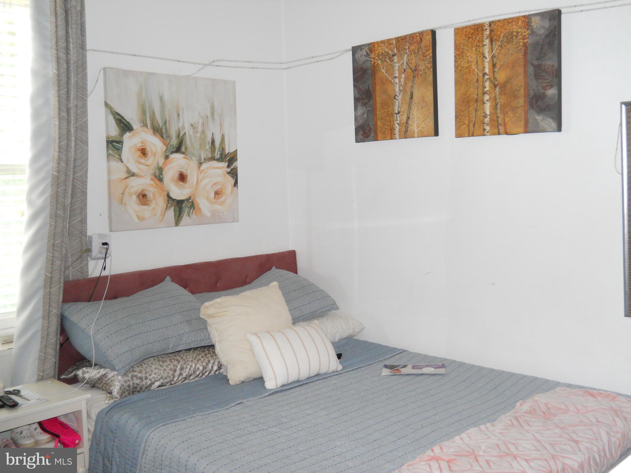 3424 Jermantown Road Fairfax, VA 22030 - Photo 10 of 19 a bedroom with a bed and a painting on the wall