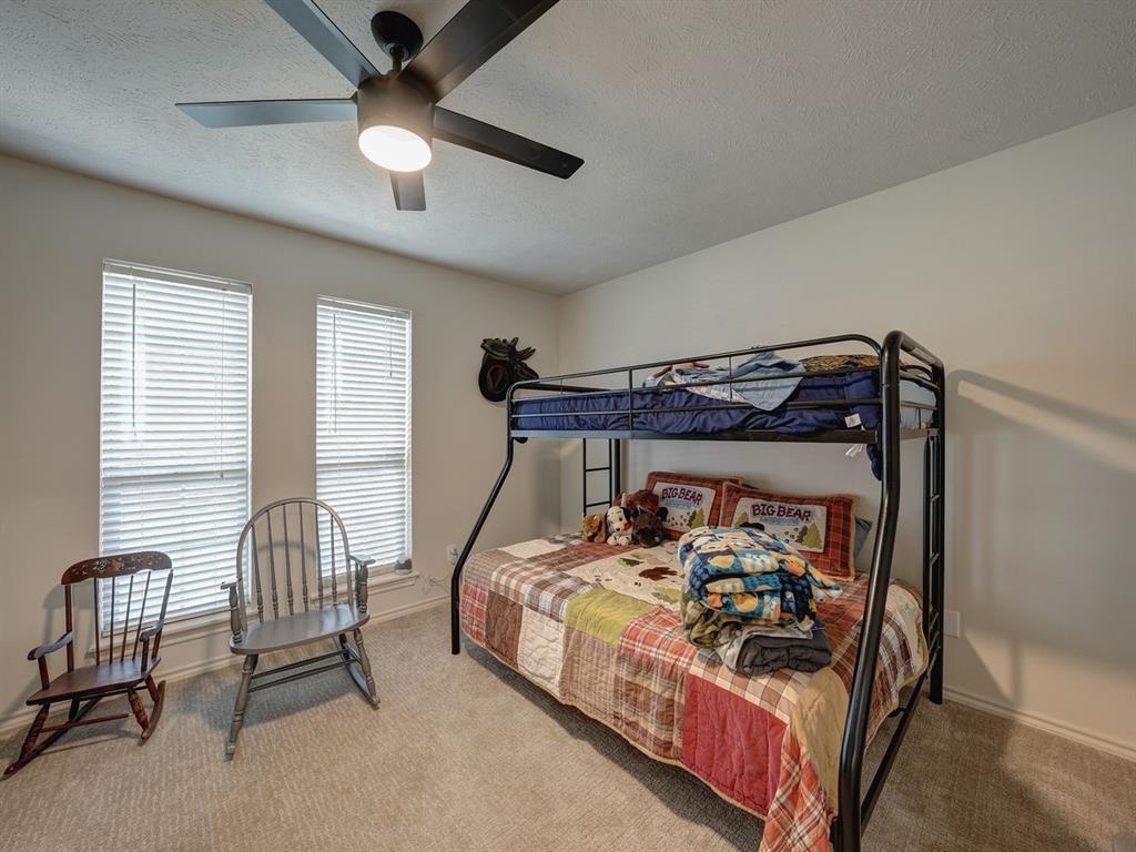 204 Boulder Ridge Circle Texarkana, AR 71854 - Photo 21 of 34 Carpeted bedroom with a textured ceiling and a ceiling fan
