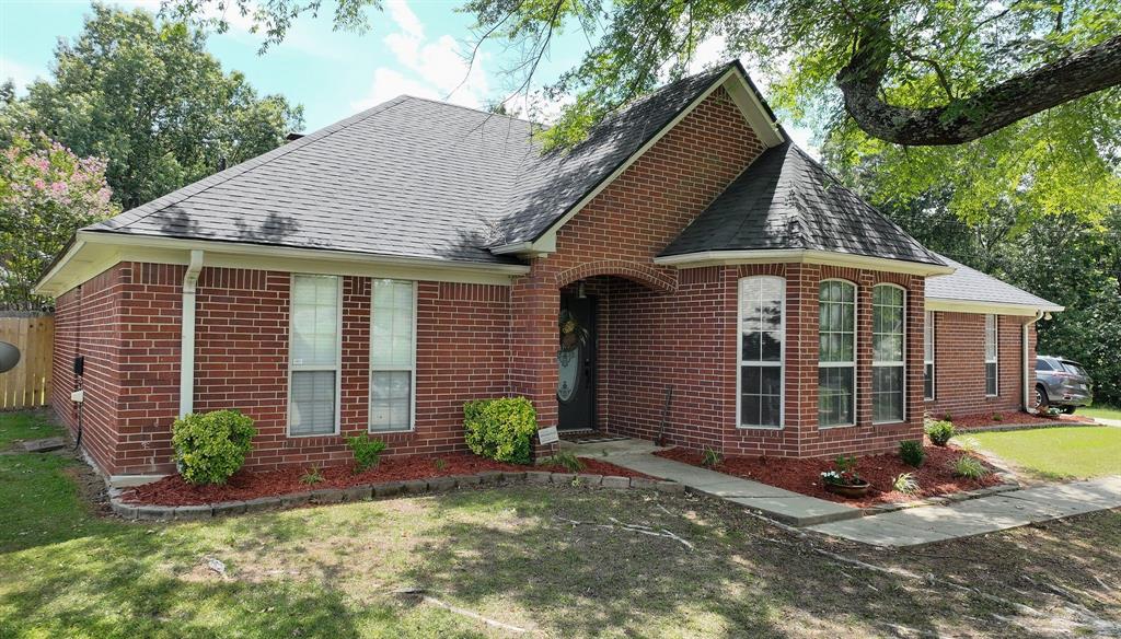 204 Boulder Ridge Circle Texarkana, AR 71854 - Photo 5 of 34 View of front of home featuring brick siding, a shingled roof, and a front lawn