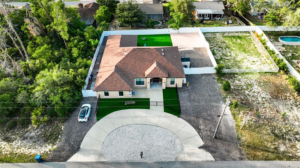 Undisclosed Address Spring Hill, FL 34608 - Photo 3 of 39 an aerial view of a house with garden space and street view