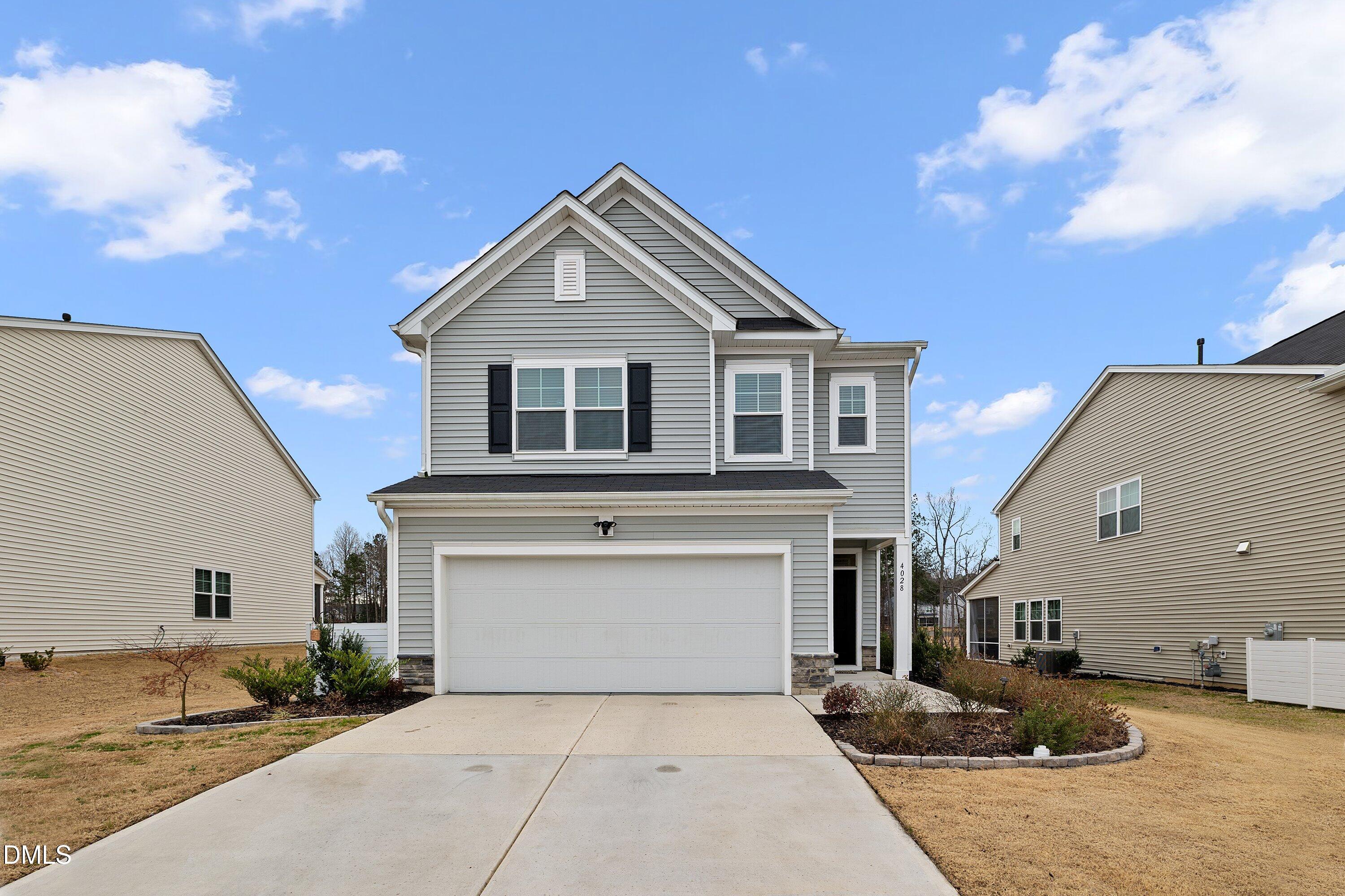 a front view of a house with garage