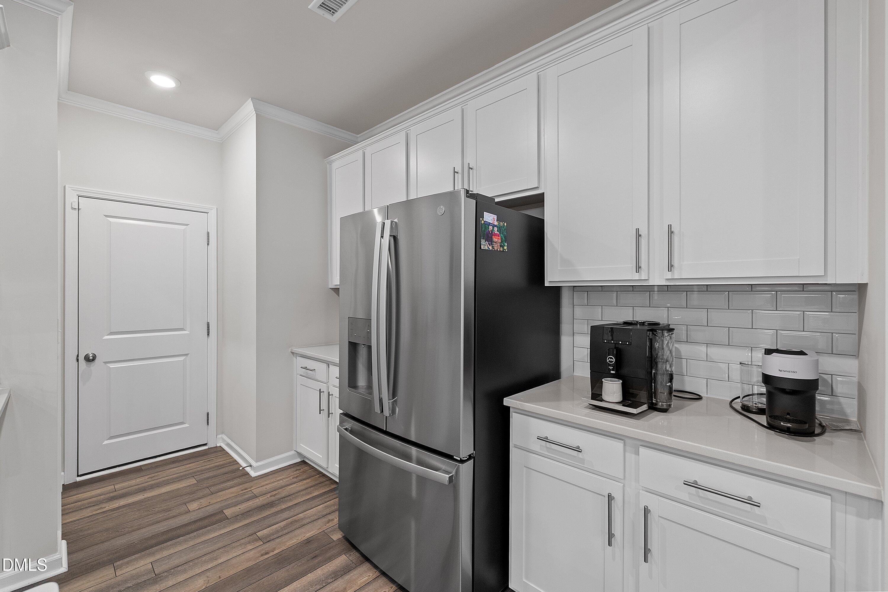 4028 Mount Moran Road Raleigh, NC 27616 - Photo 12 of 46 a kitchen with stainless steel appliances white cabinets and a refrigerator