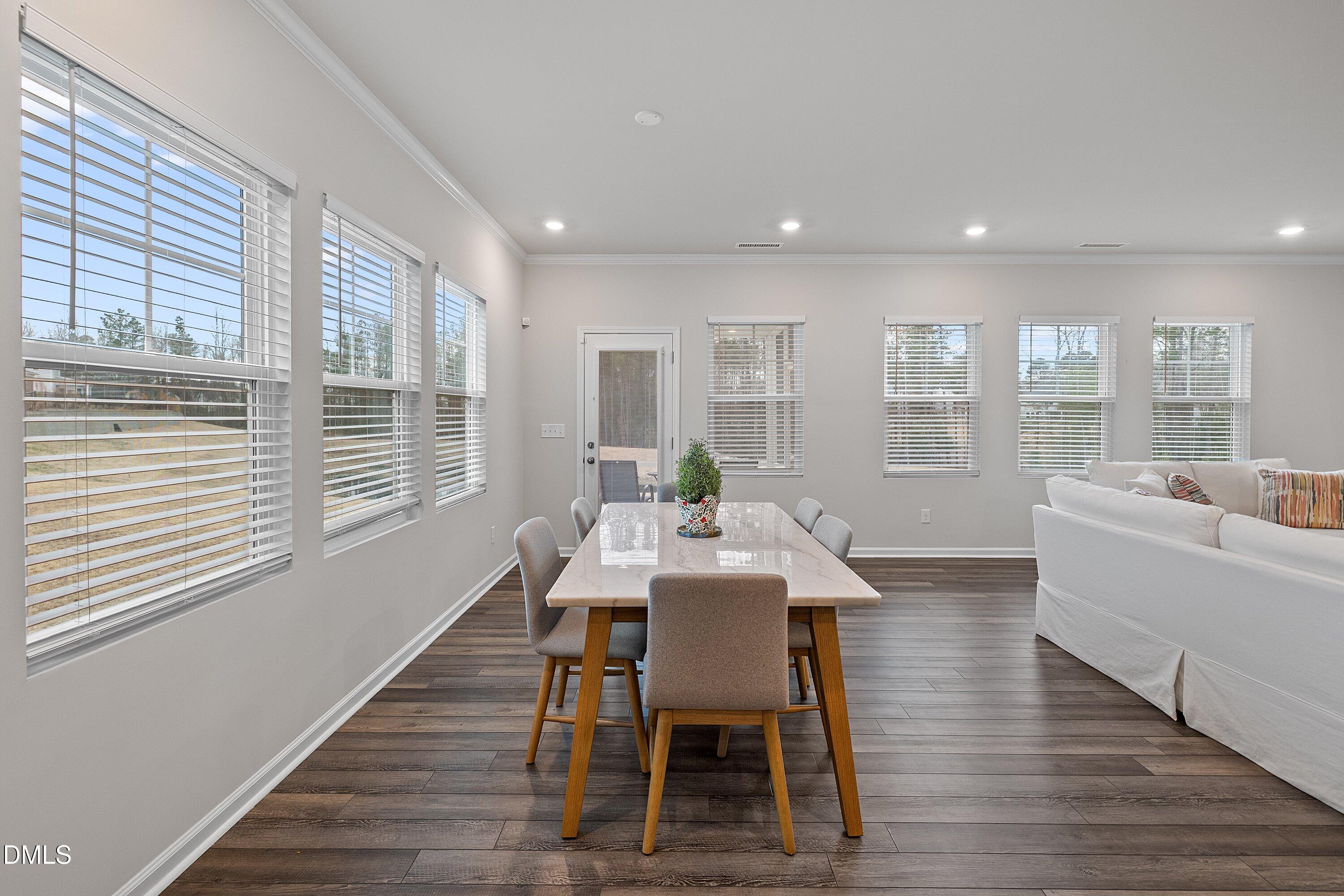 4028 Mount Moran Road Raleigh, NC 27616 - Photo 14 of 46 a view of a dining room with furniture and wooden floor