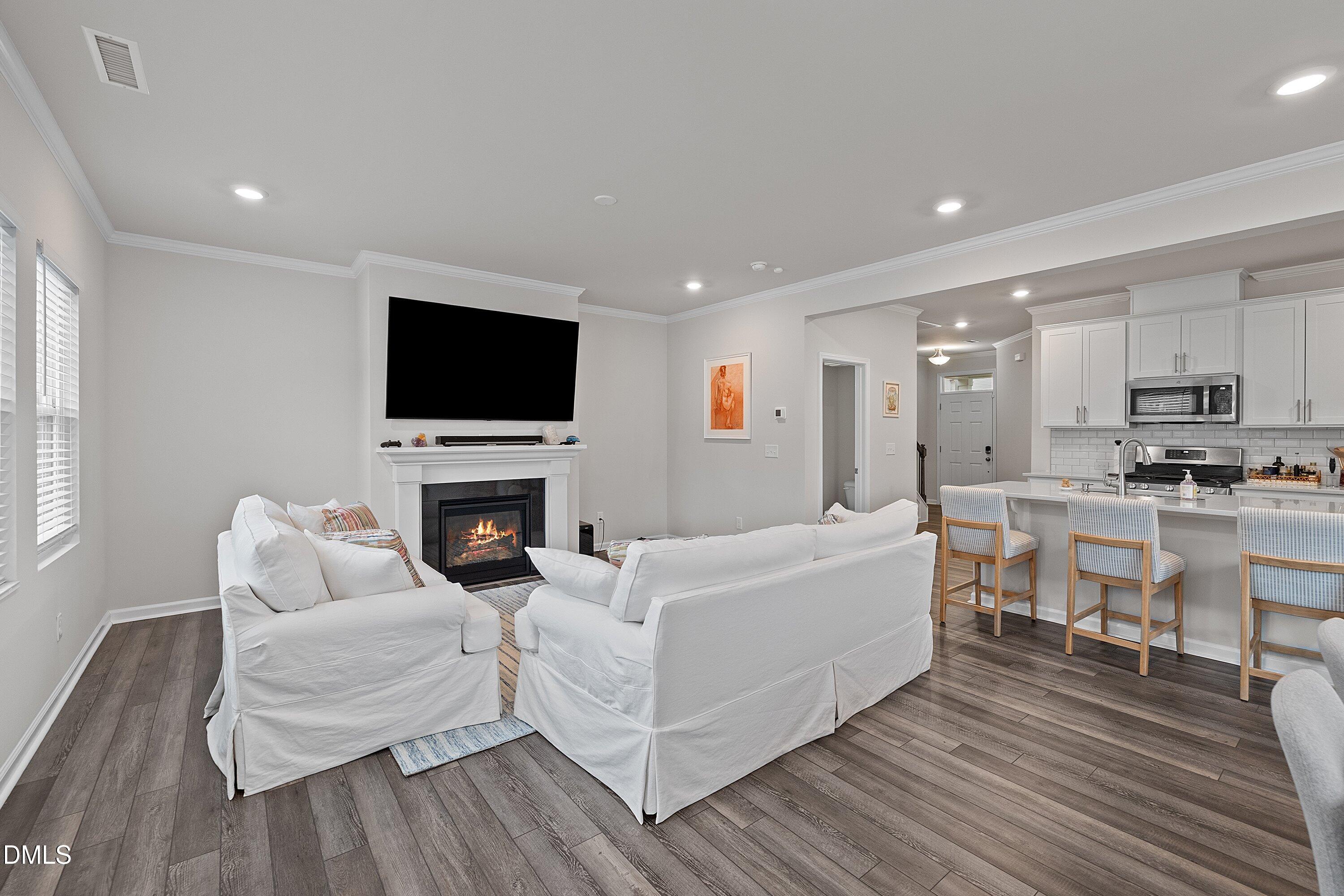 4028 Mount Moran Road Raleigh, NC 27616 - Photo 16 of 46 a living room with fireplace furniture and a flat screen tv
