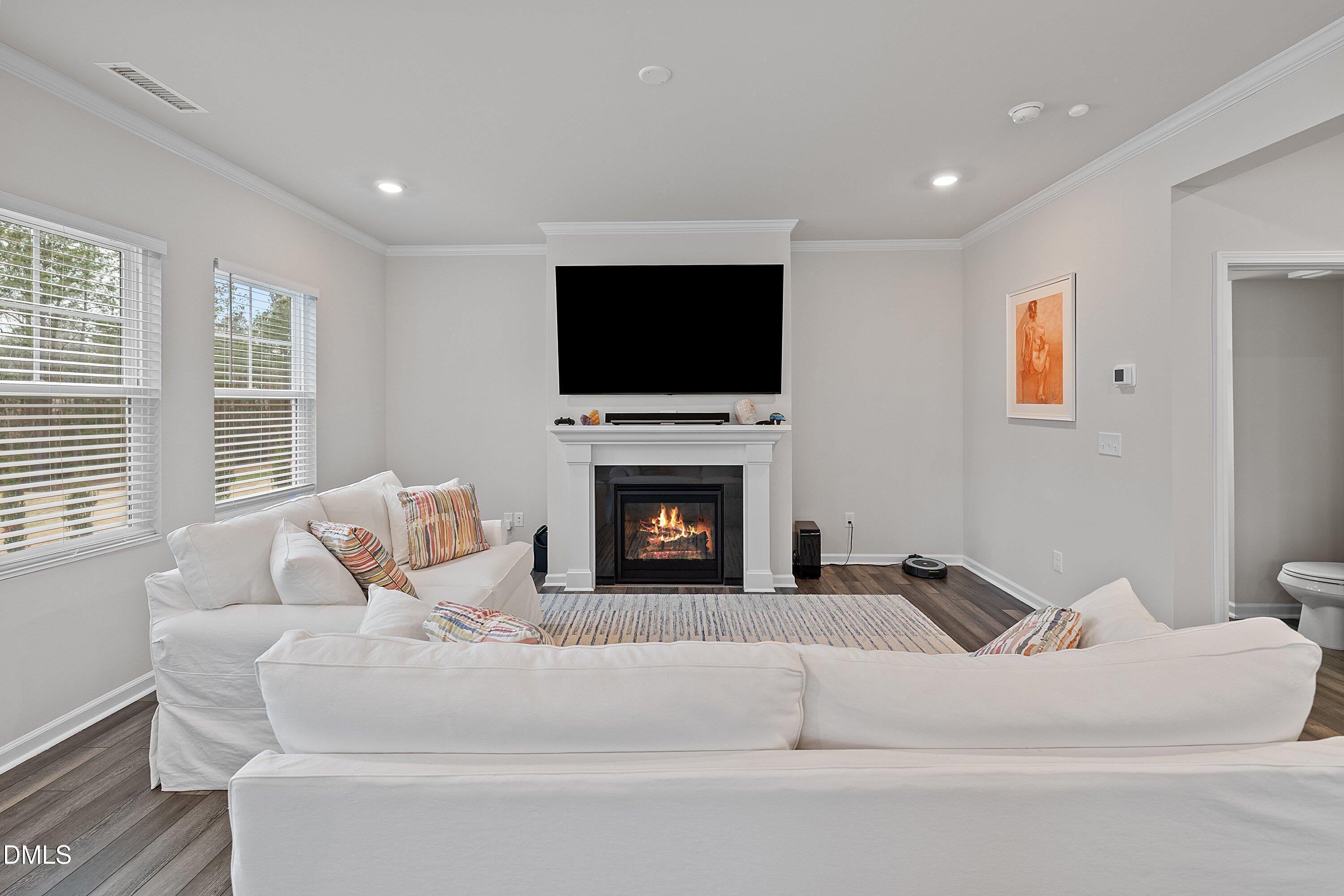 4028 Mount Moran Road Raleigh, NC 27616 - Photo 17 of 46 a living room with furniture a flat screen tv and a fireplace