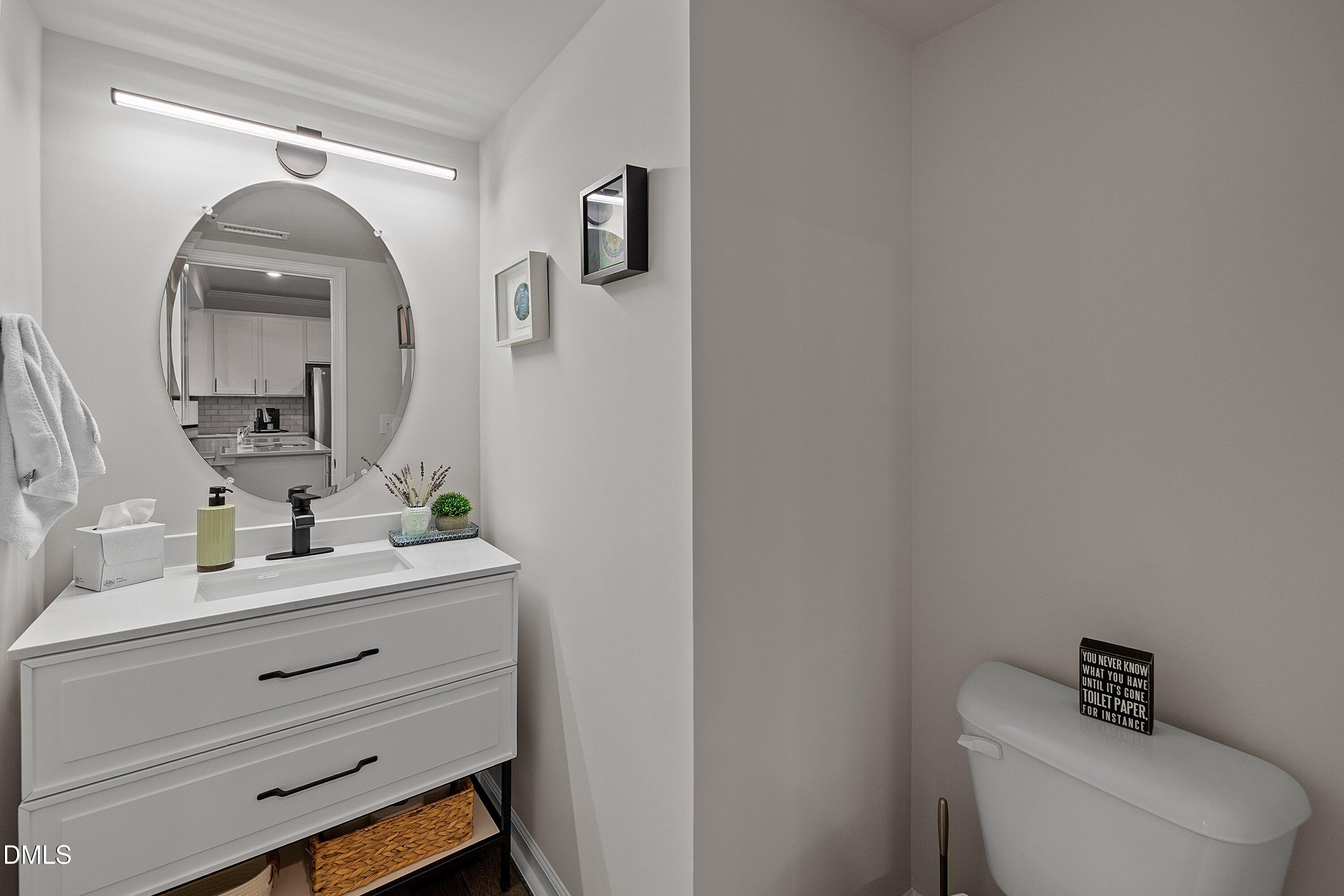 4028 Mount Moran Road Raleigh, NC 27616 - Photo 21 of 46 a bathroom with a toilet sink and mirror