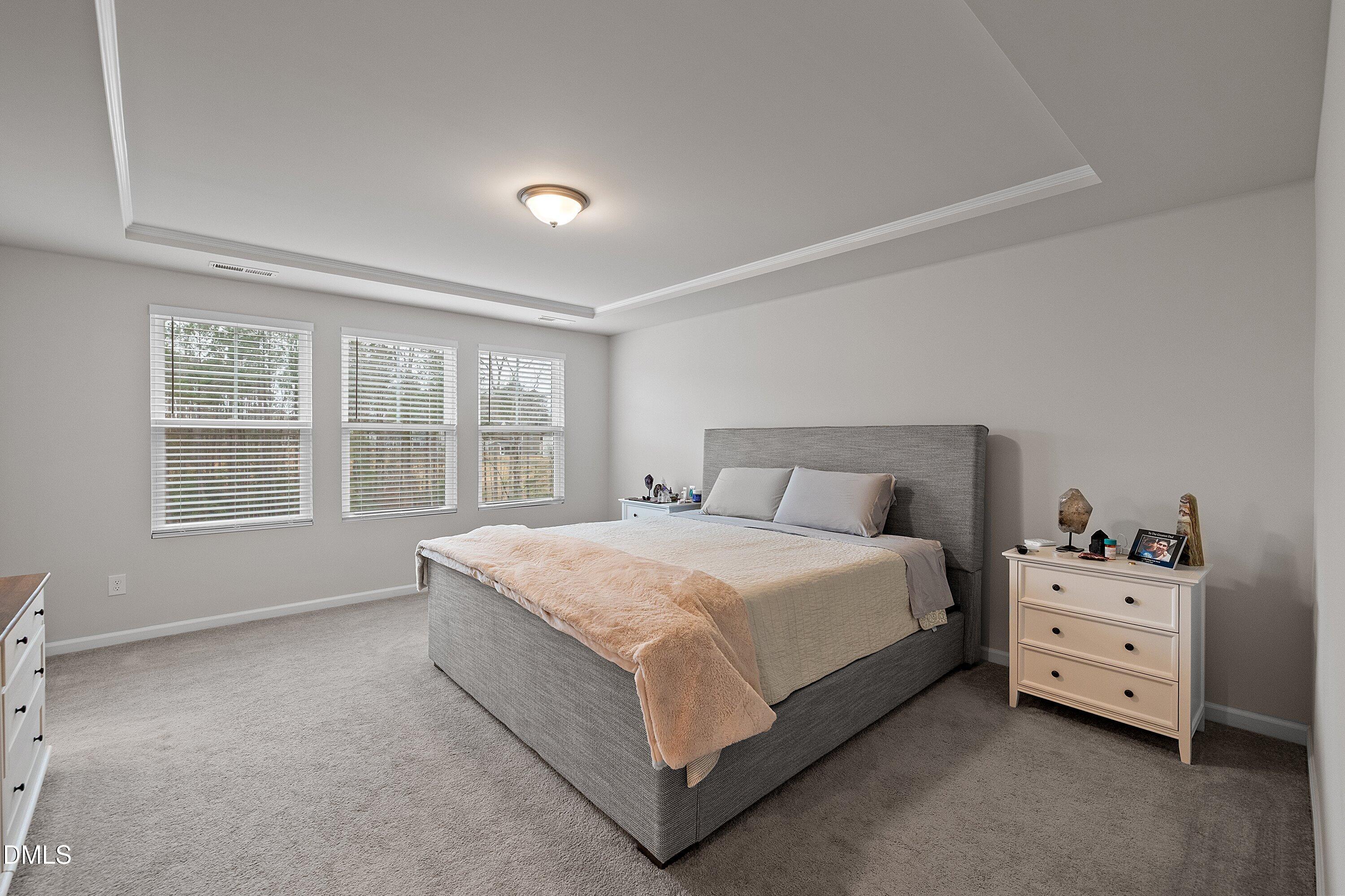 4028 Mount Moran Road Raleigh, NC 27616 - Photo 22 of 46 a large bed sitting in a bedroom next to a window
