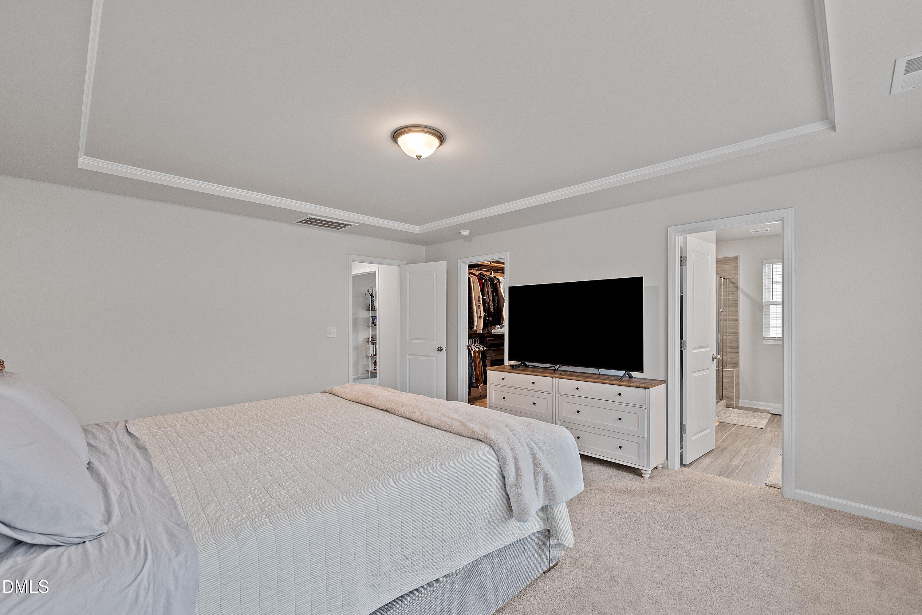 4028 Mount Moran Road Raleigh, NC 27616 - Photo 24 of 46 a bedroom with a bed and a flat screen tv