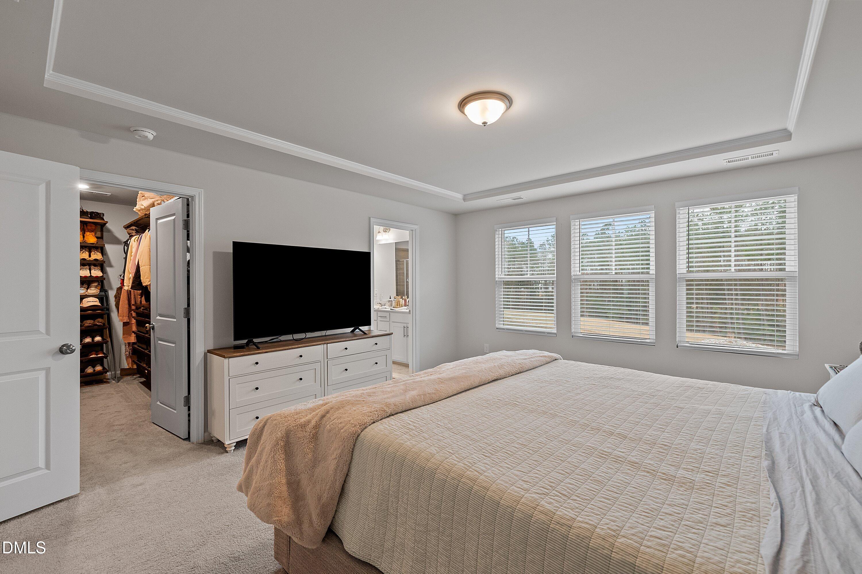 4028 Mount Moran Road Raleigh, NC 27616 - Photo 25 of 46 a bedroom with bed and a flat tv screen on wall