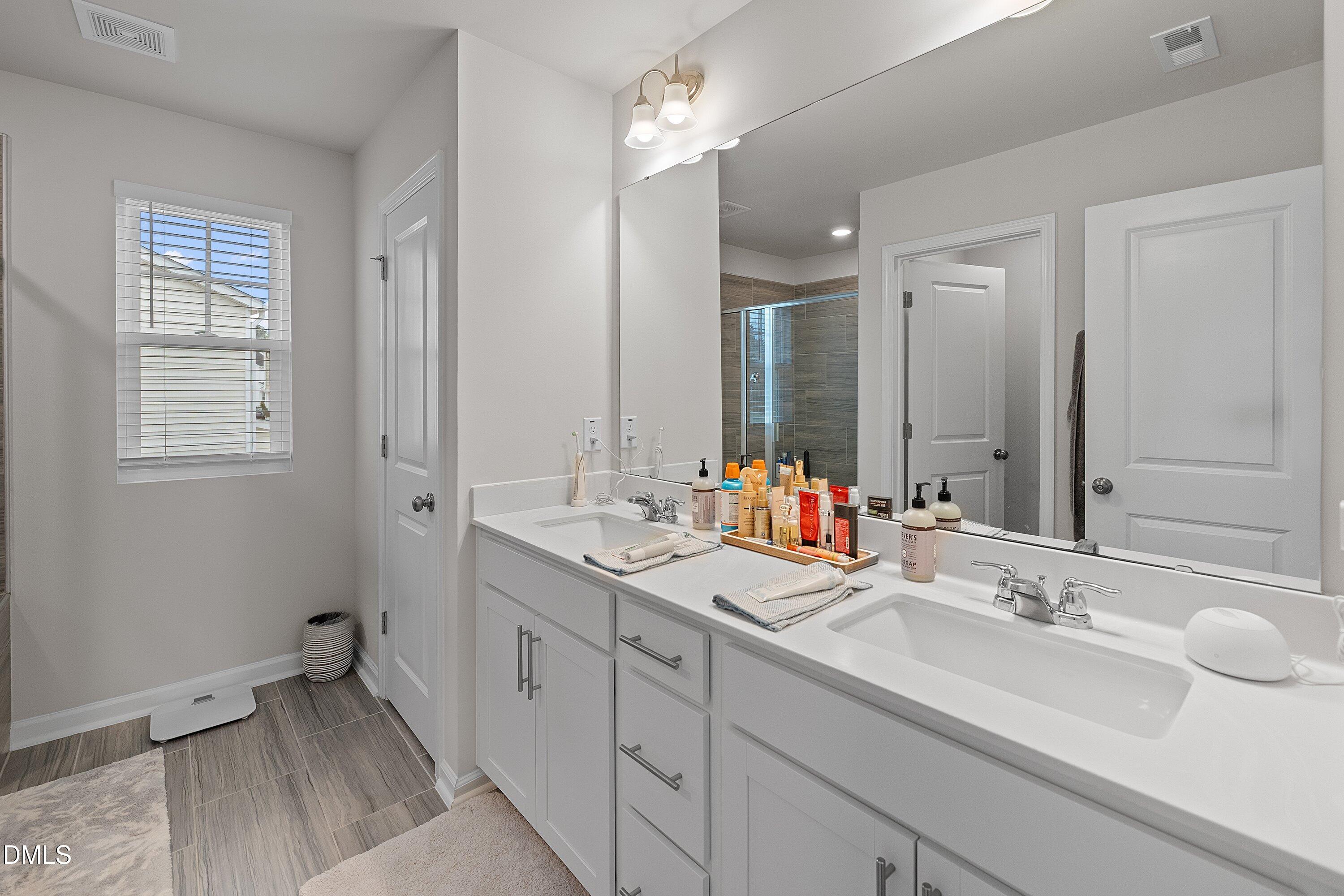 4028 Mount Moran Road Raleigh, NC 27616 - Photo 26 of 46 a bathroom with double sink and a mirror