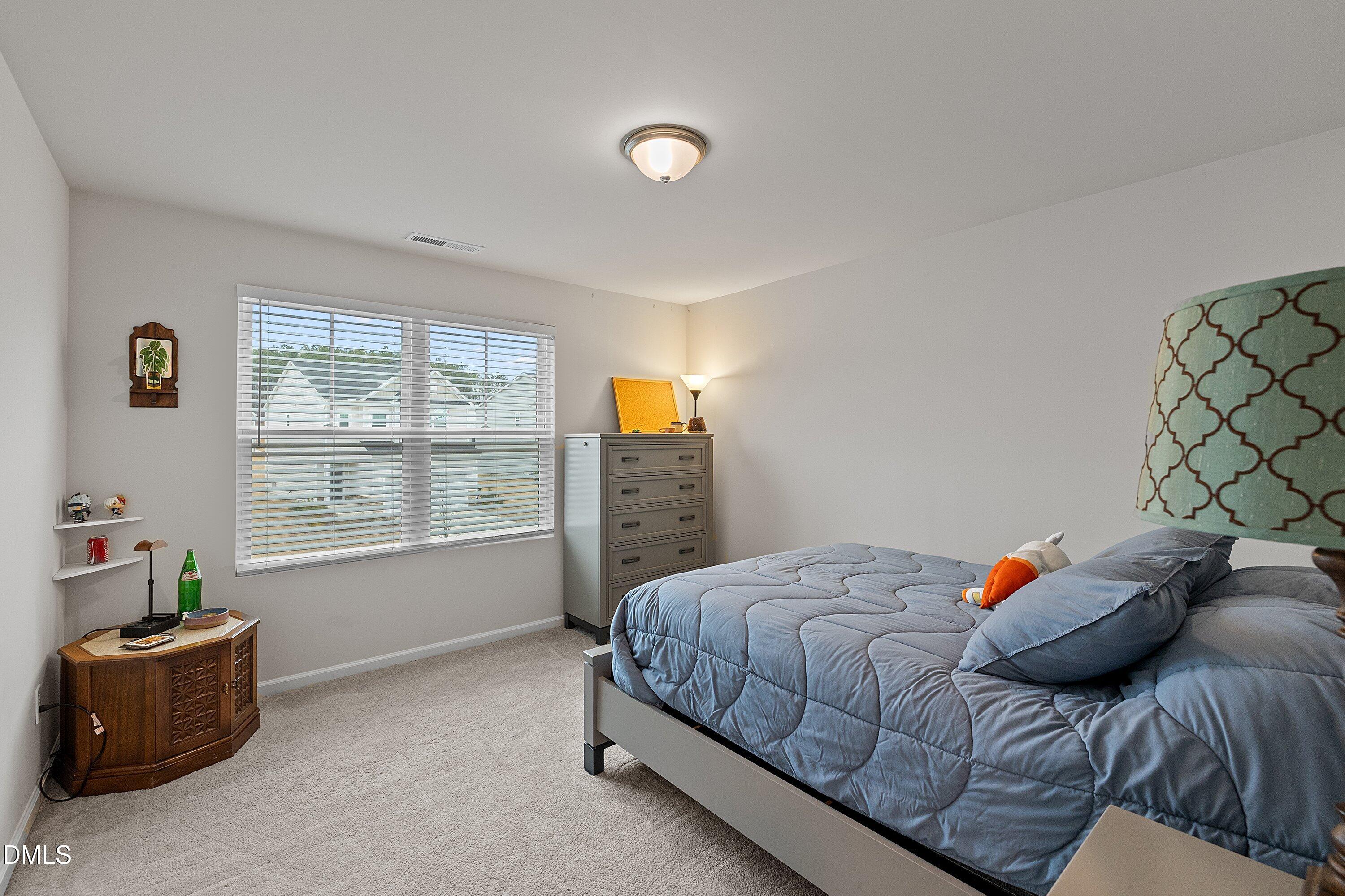 4028 Mount Moran Road Raleigh, NC 27616 - Photo 30 of 46 a bedroom with a bed and a couch