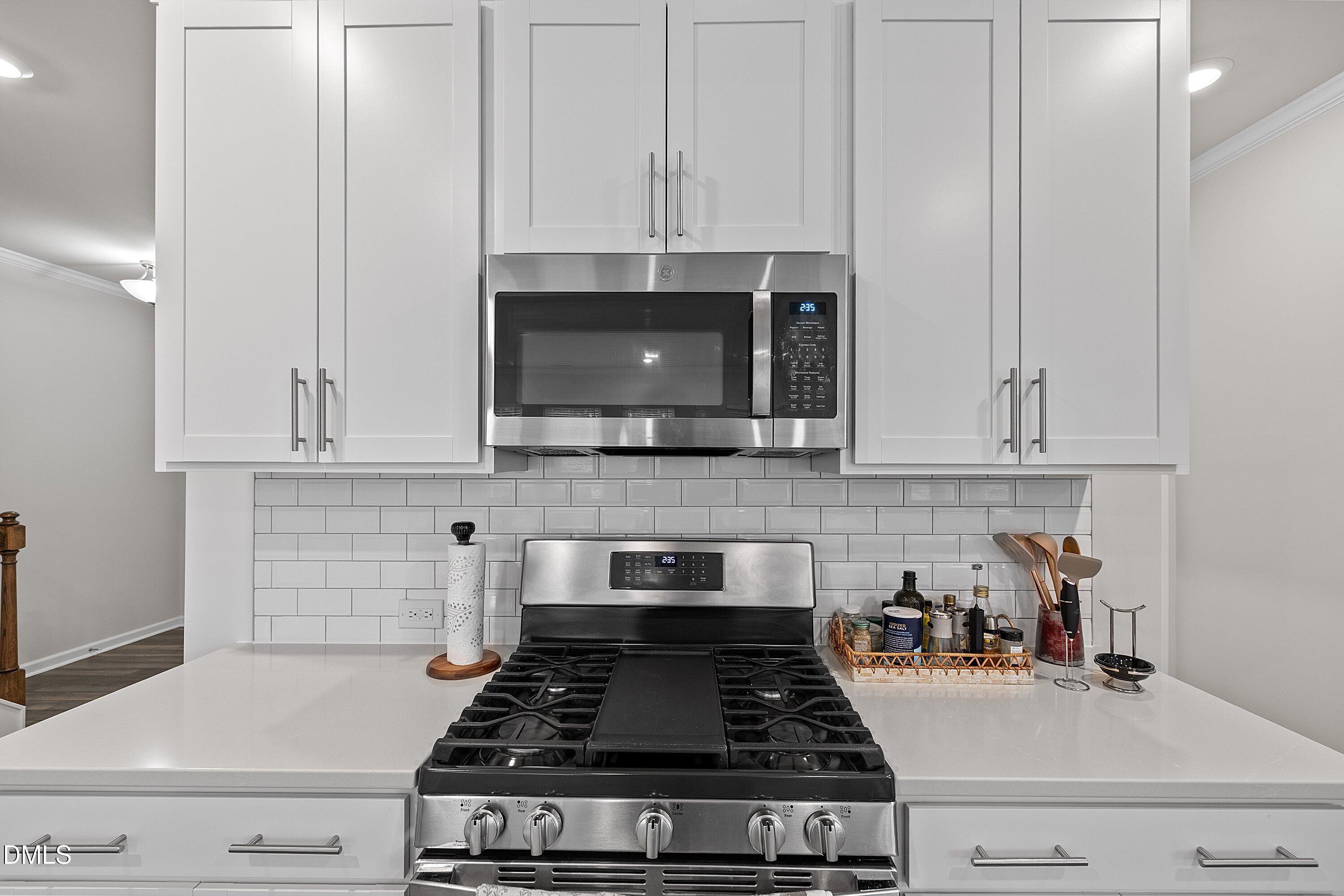 4028 Mount Moran Road Raleigh, NC 27616 - Photo 9 of 46 a kitchen with stainless steel appliances granite countertop white cabinets and stove