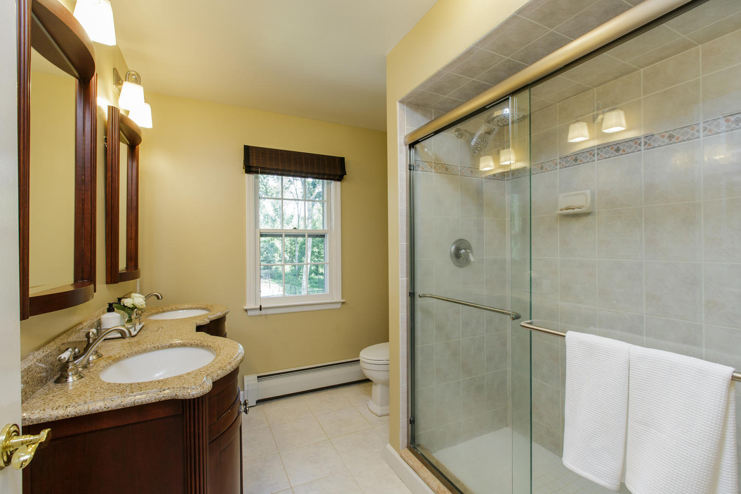 73 Talmadge Hill Road New Canaan, CT 06840 - Photo 15 of 37 a bathroom with a granite countertop sink mirror and a shower