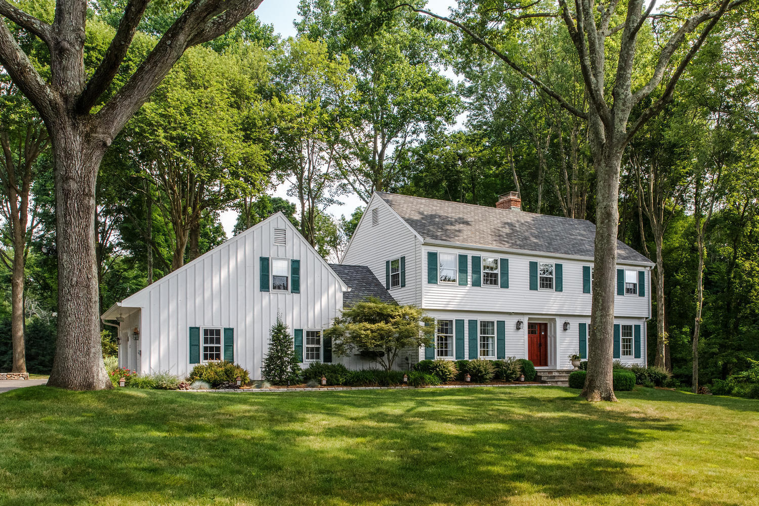 73 Talmadge Hill Road New Canaan, CT 06840 - Photo 2 of 37 a front view of a house with a garden