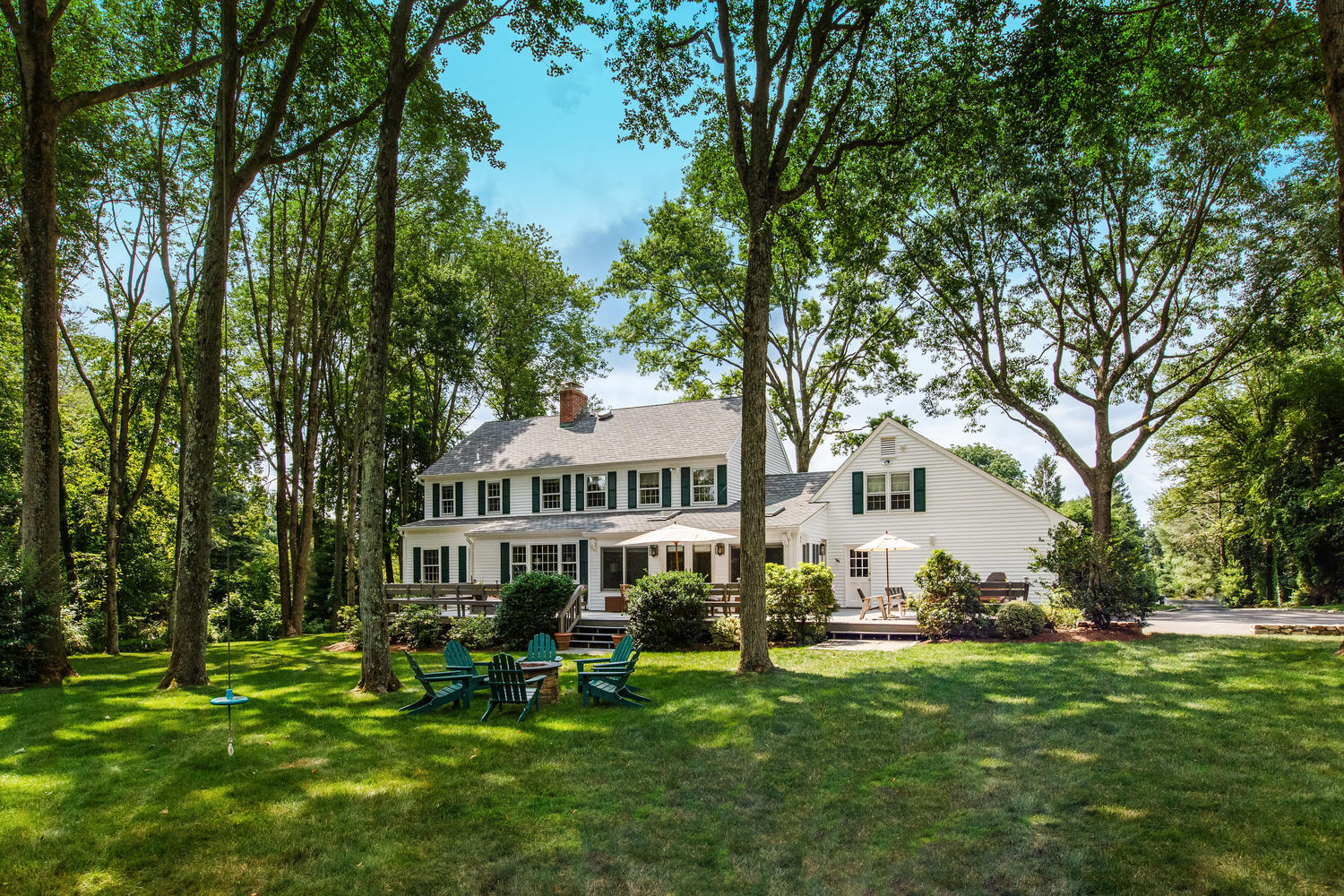 73 Talmadge Hill Road New Canaan, CT 06840 - Photo 28 of 37 a front view of a house with a garden and trees